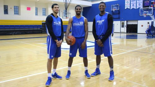 Three Ryerson Basketball team captains stand on the court
