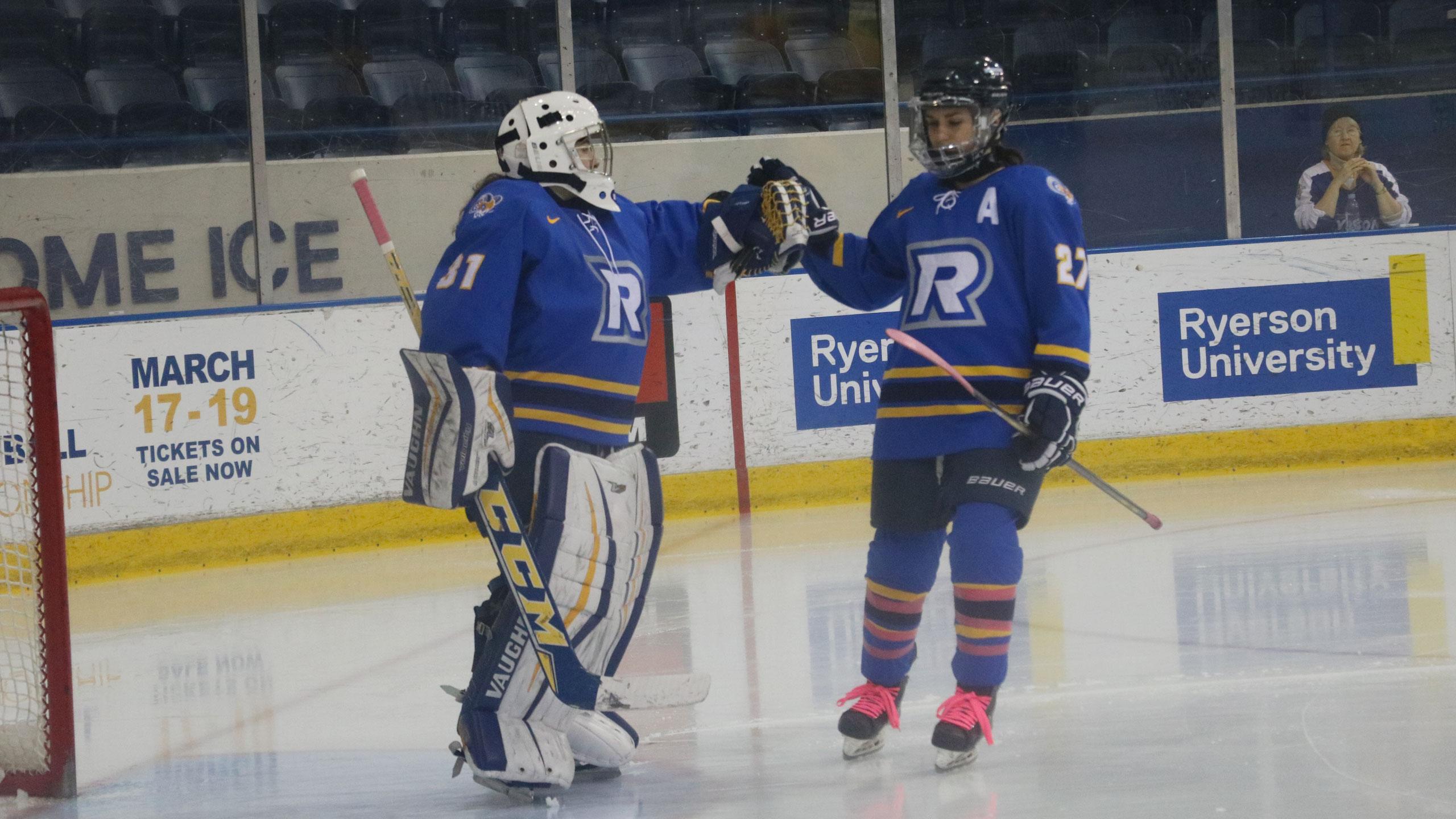 Two ryerson hockey players bump hands