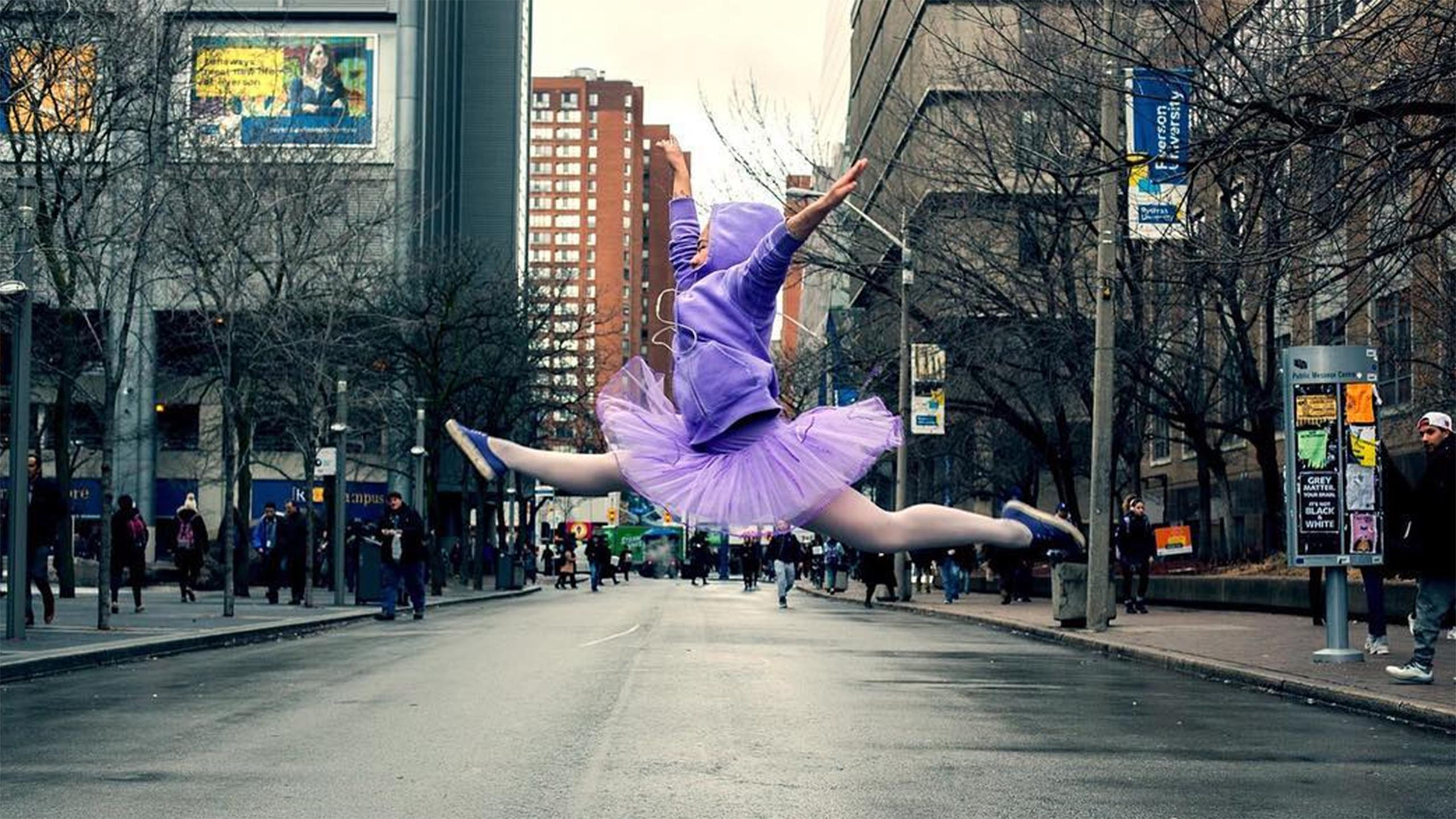 a ballerina dressed in purple prances across Gould Street