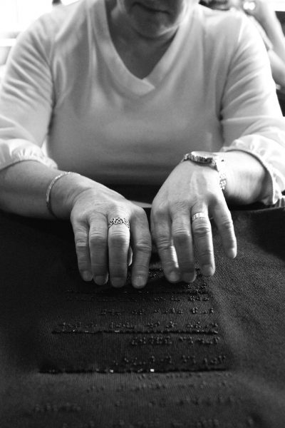 A woman reading braille.