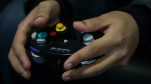 Monib's hands on a controller