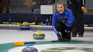 A curling player watches the ice