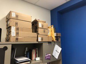 a lot of amazon cardboard boxes stacked onto a shelf