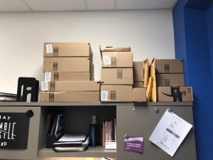 a lot of amazon cardboard boxes stacked onto a shelf