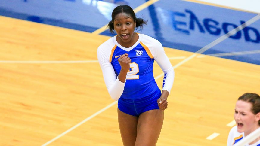 A Rams women's volleyball player in a blue jersey celebrates a point