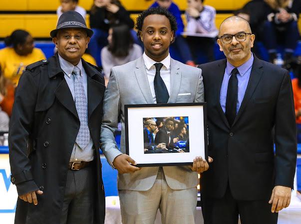 Man holding posing for senior night photo