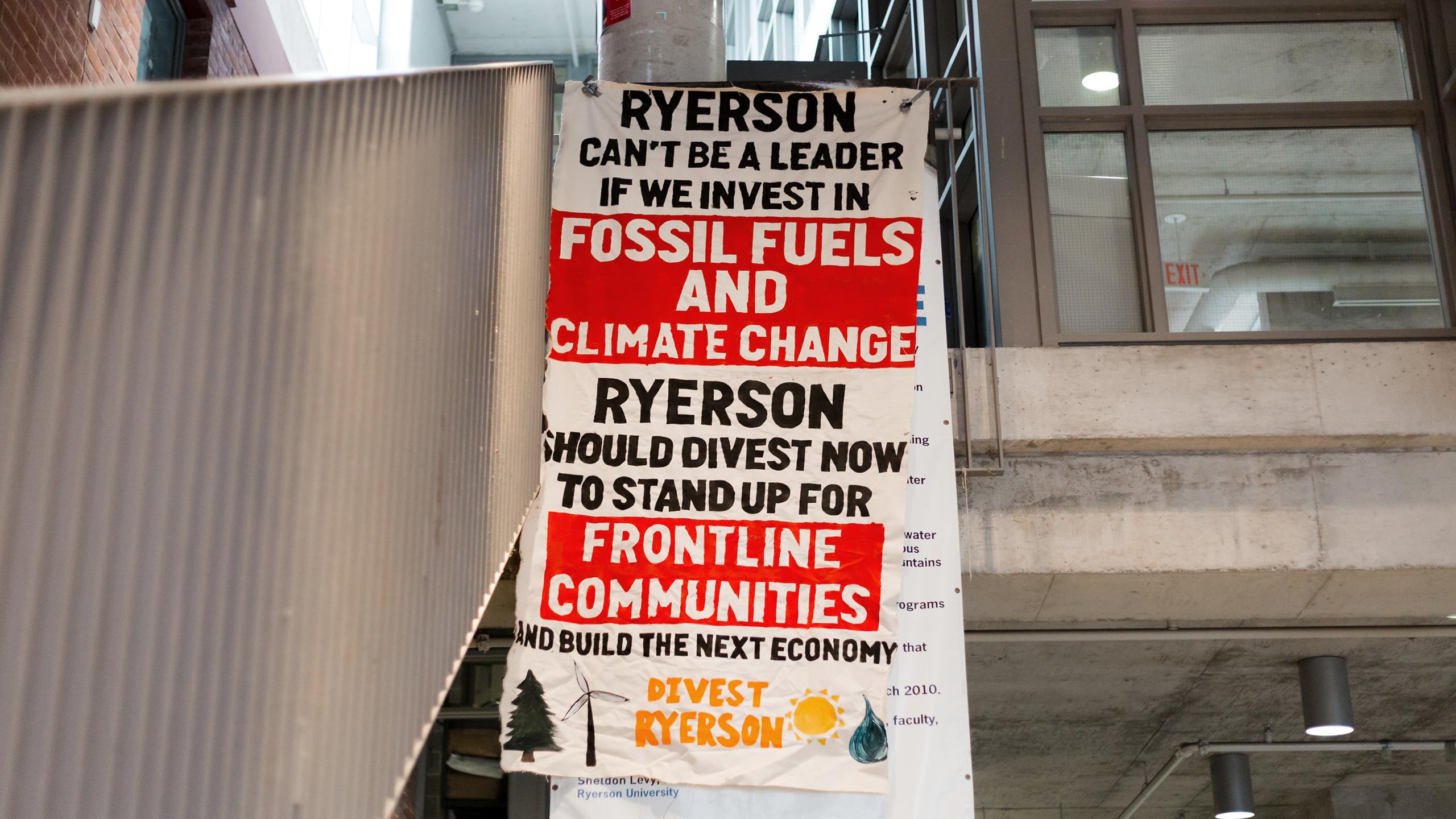 A painted banner that says Ryerson should divest