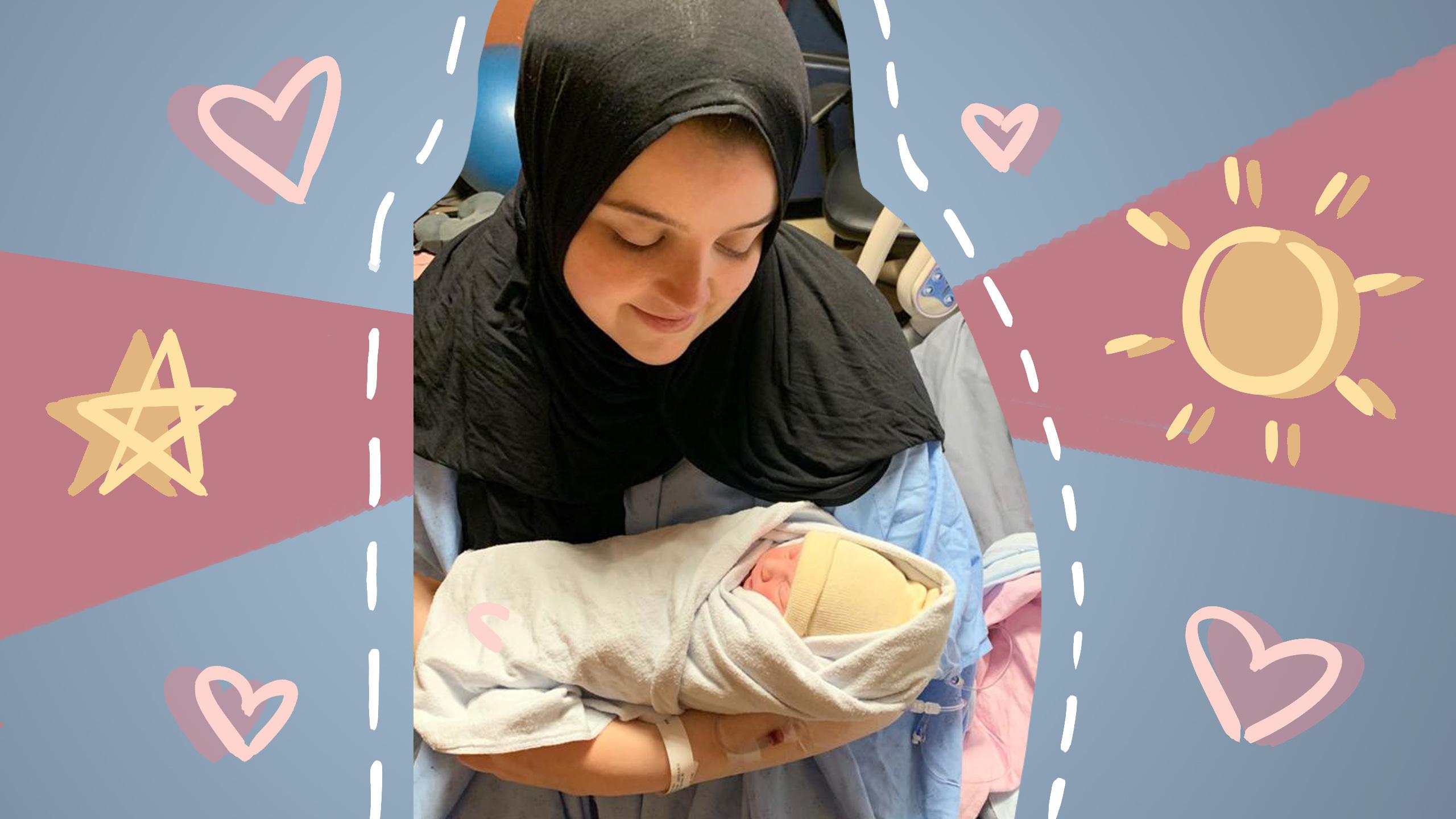 A smiling woman sitting in a hospital bed wearing a hijab holding a newborn baby in her arms.