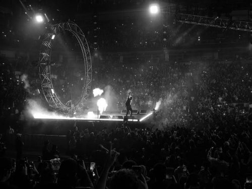 A man on stage in a concert arena.