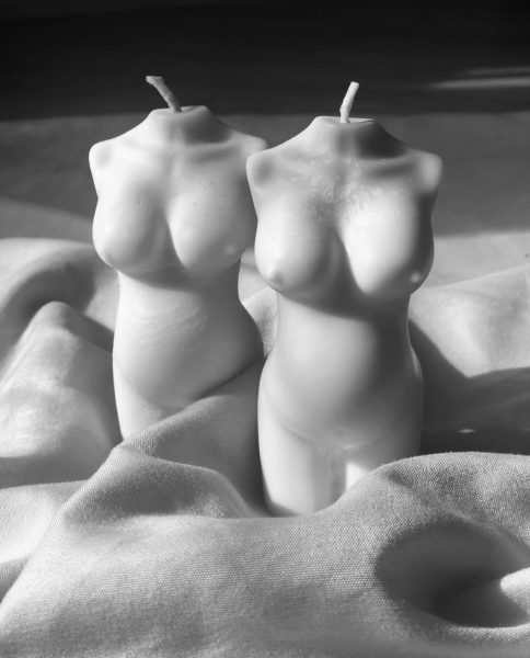 Two candles, in the shape of the feminine body form