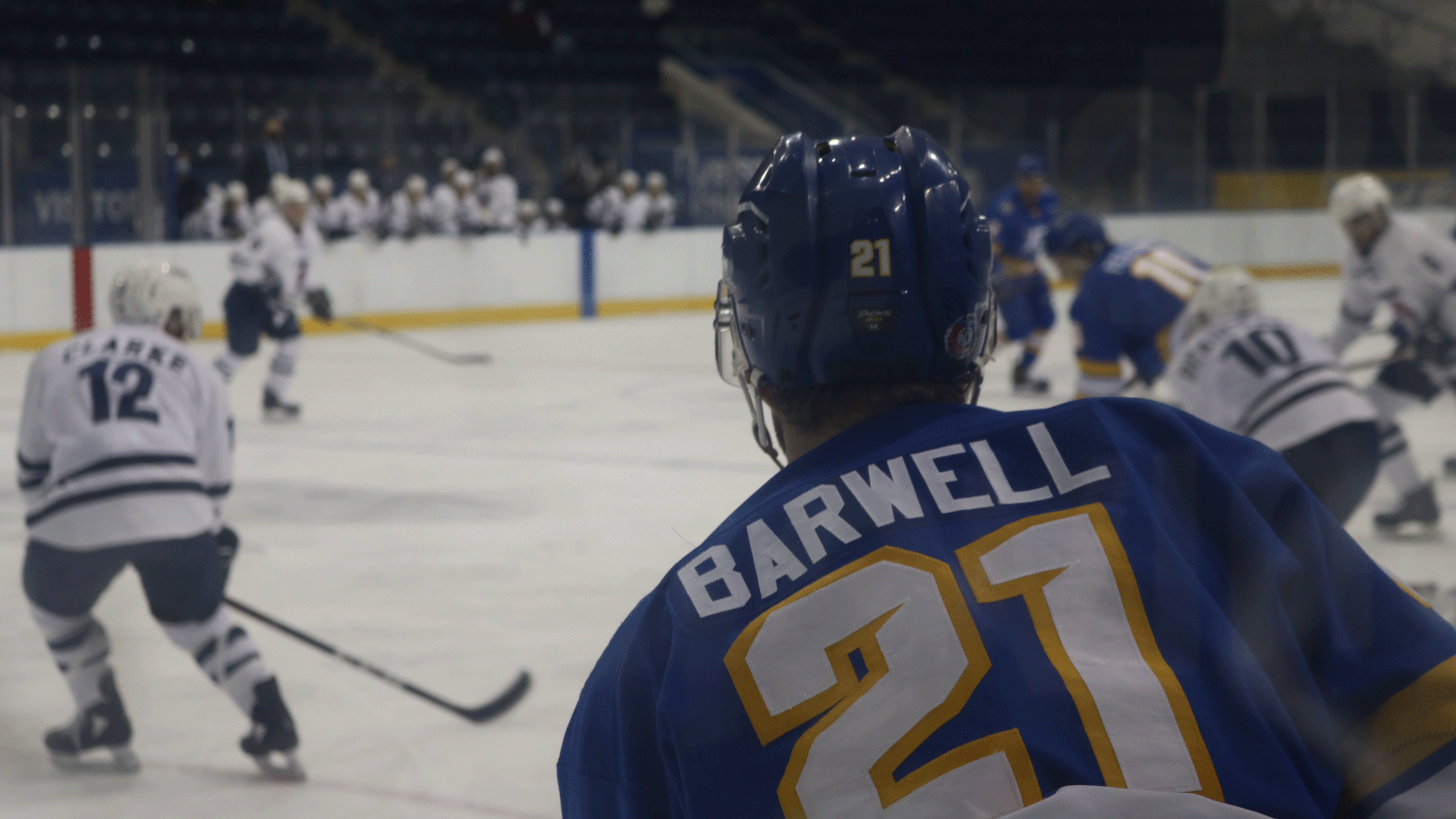 A Rams men's hockey player with the last name "Barwell" on his blue jersey comes into frame