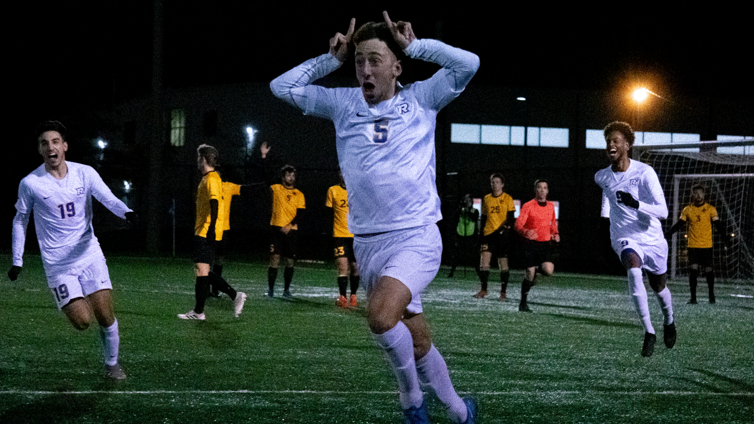 A Rams men's soccer player celebrates a goal by putting horns on his head