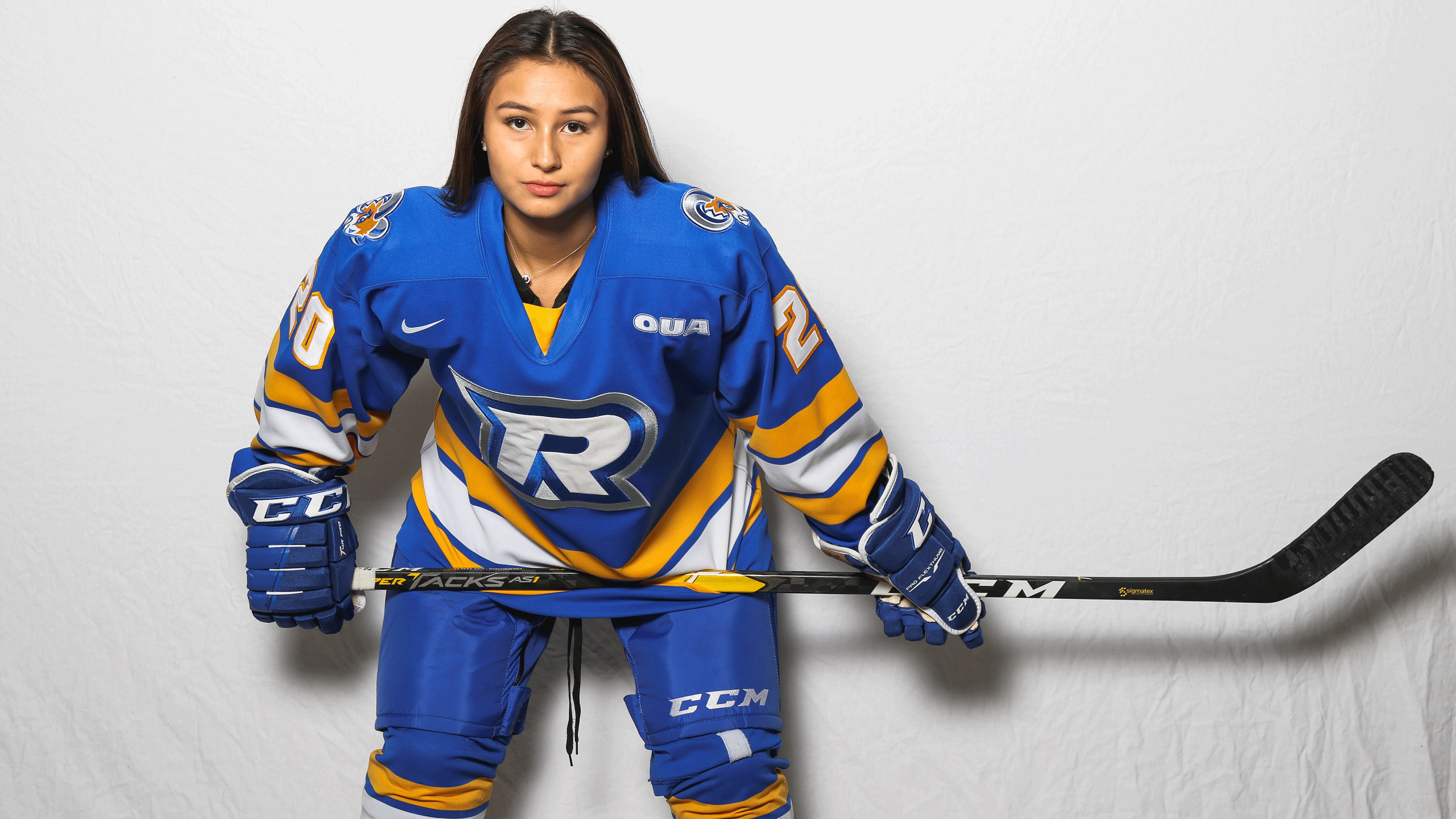 A Rams women's hockey forward in a blue jerseys poses for the camera
