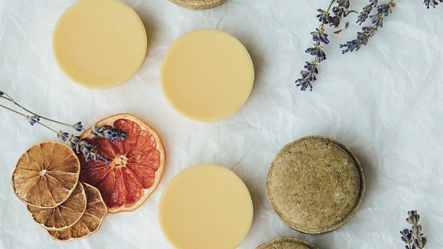 Soap surrounded by dried lavender and oranges