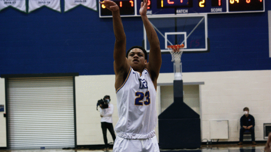 A Rams men's basketball player in a white jersey shoots a free throw