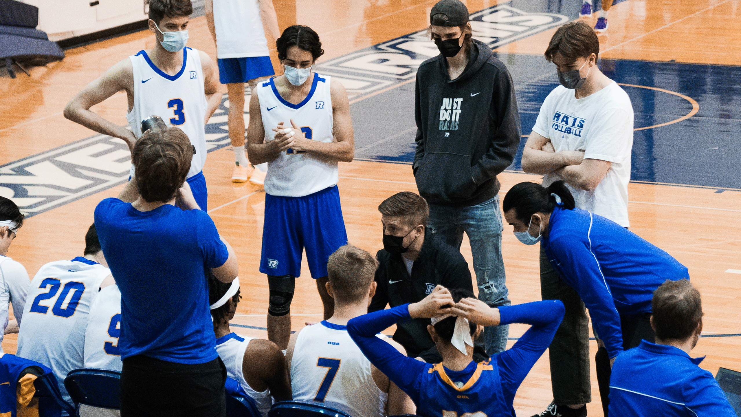 The Rams men's volleyball team huddles in a timeout