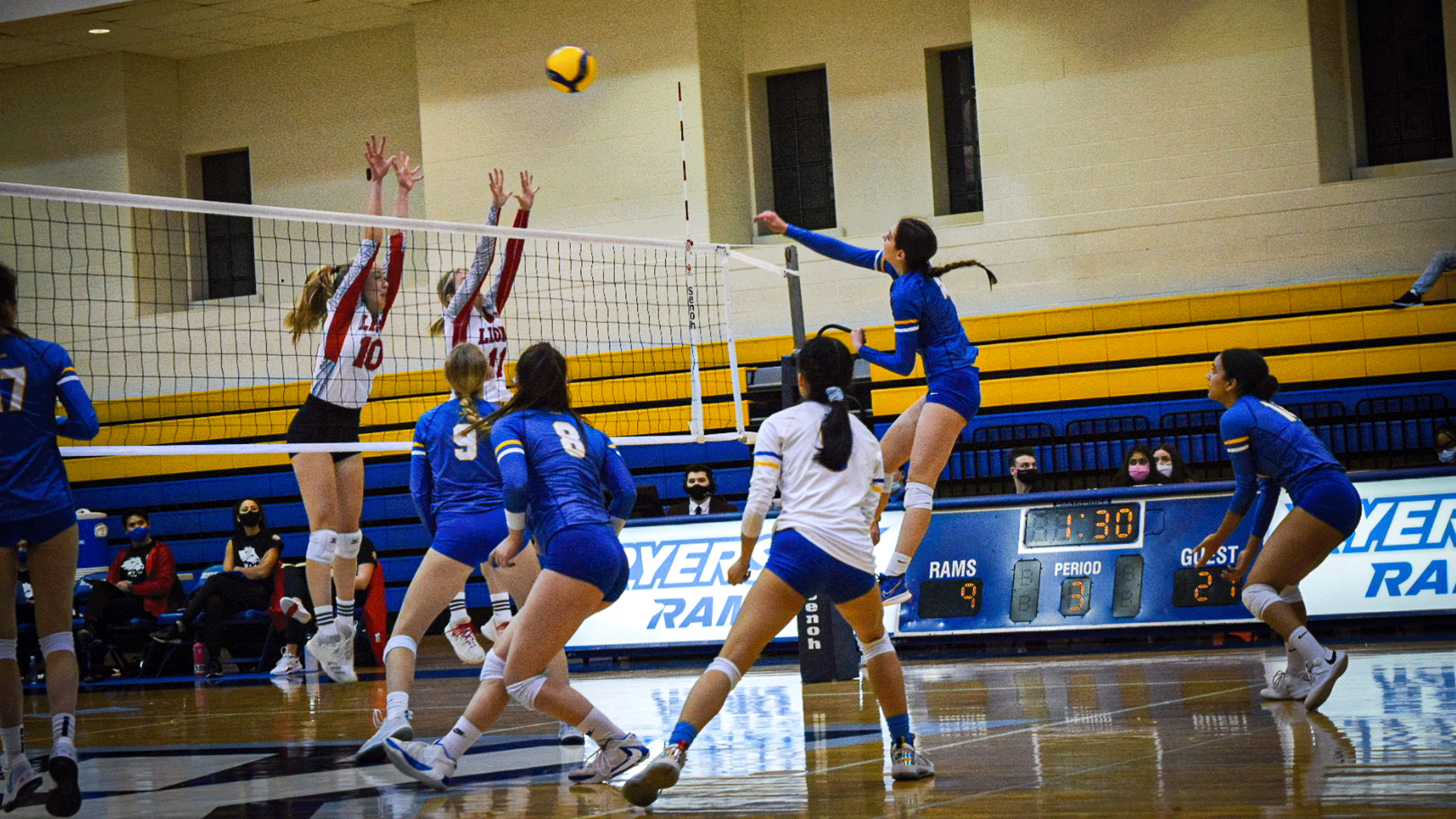 The Rams women's volleyball team attempt to clear the net