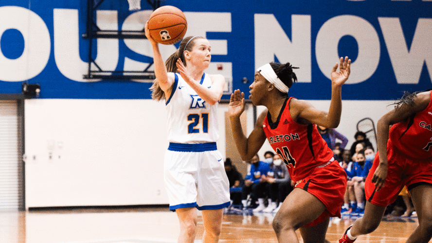 A Rams women's basketball player in a white jersey passes the ball