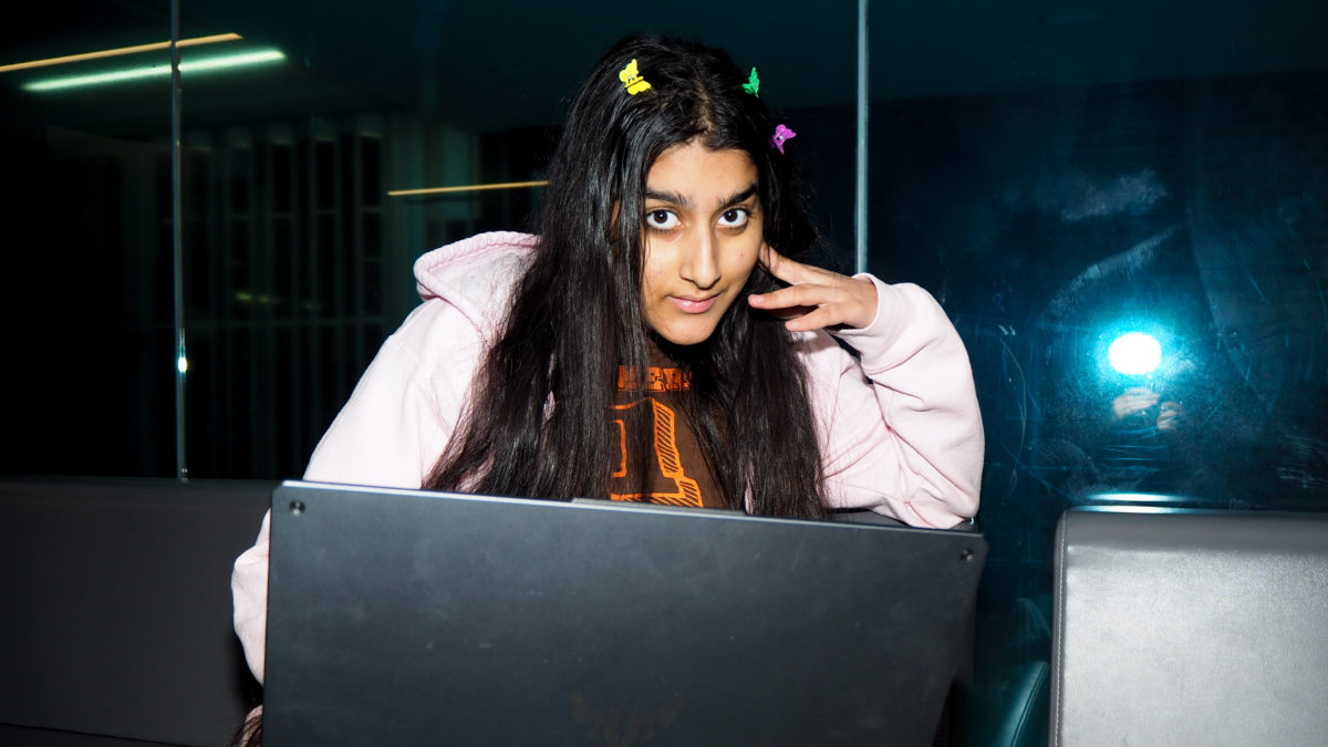 Angelina Nayyar looking indignantly at a laptop