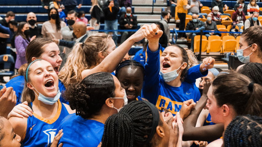 The Rams women's basketball team celebrates a win