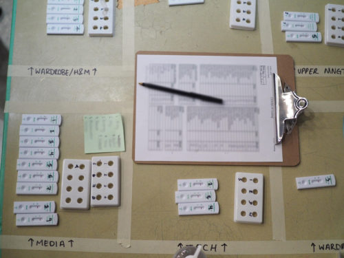 A clipboard surrounded by rapid COVID tests.