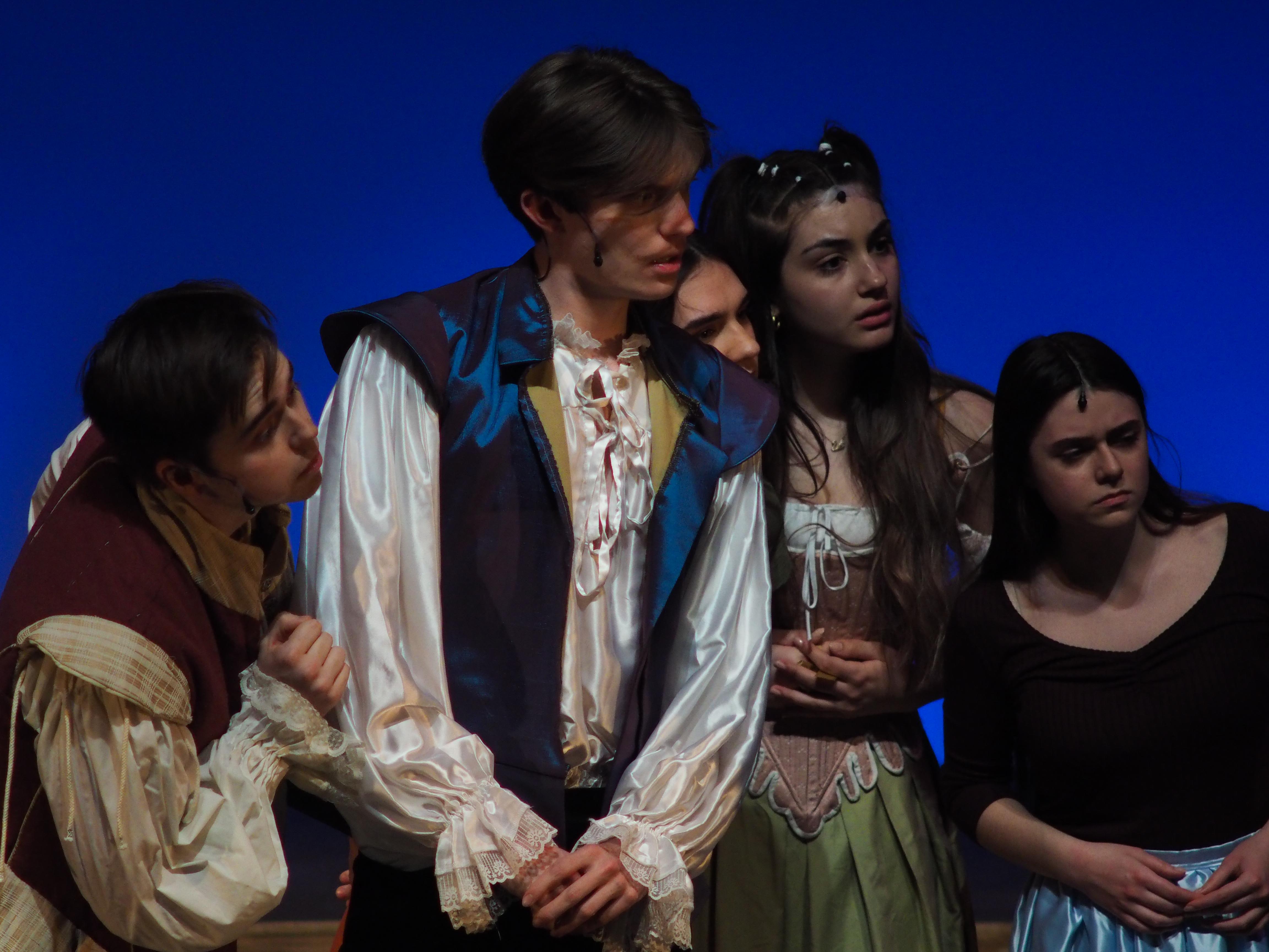 Five actors on stage during the dress rehearsal.