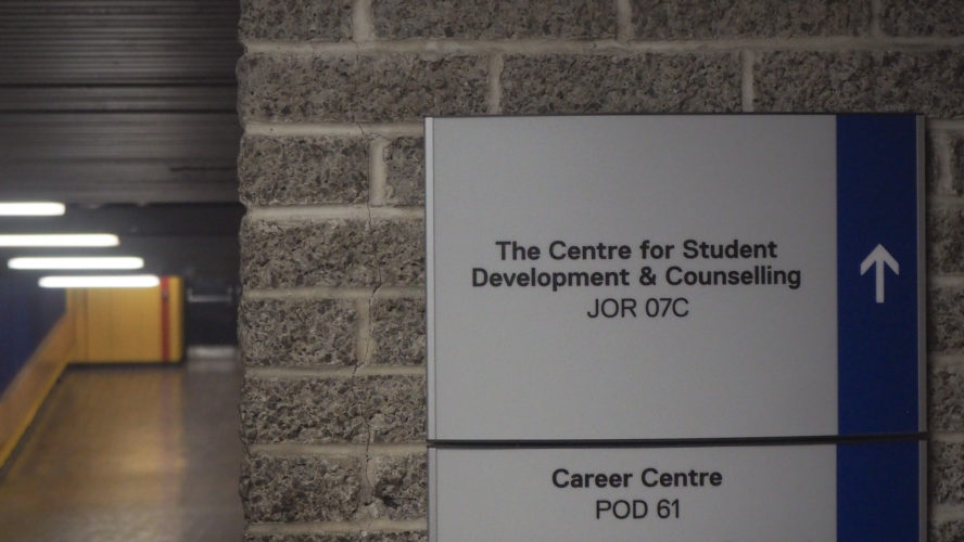 A sign in a long hallway that reads "The Centre for Student Development and Counselling"