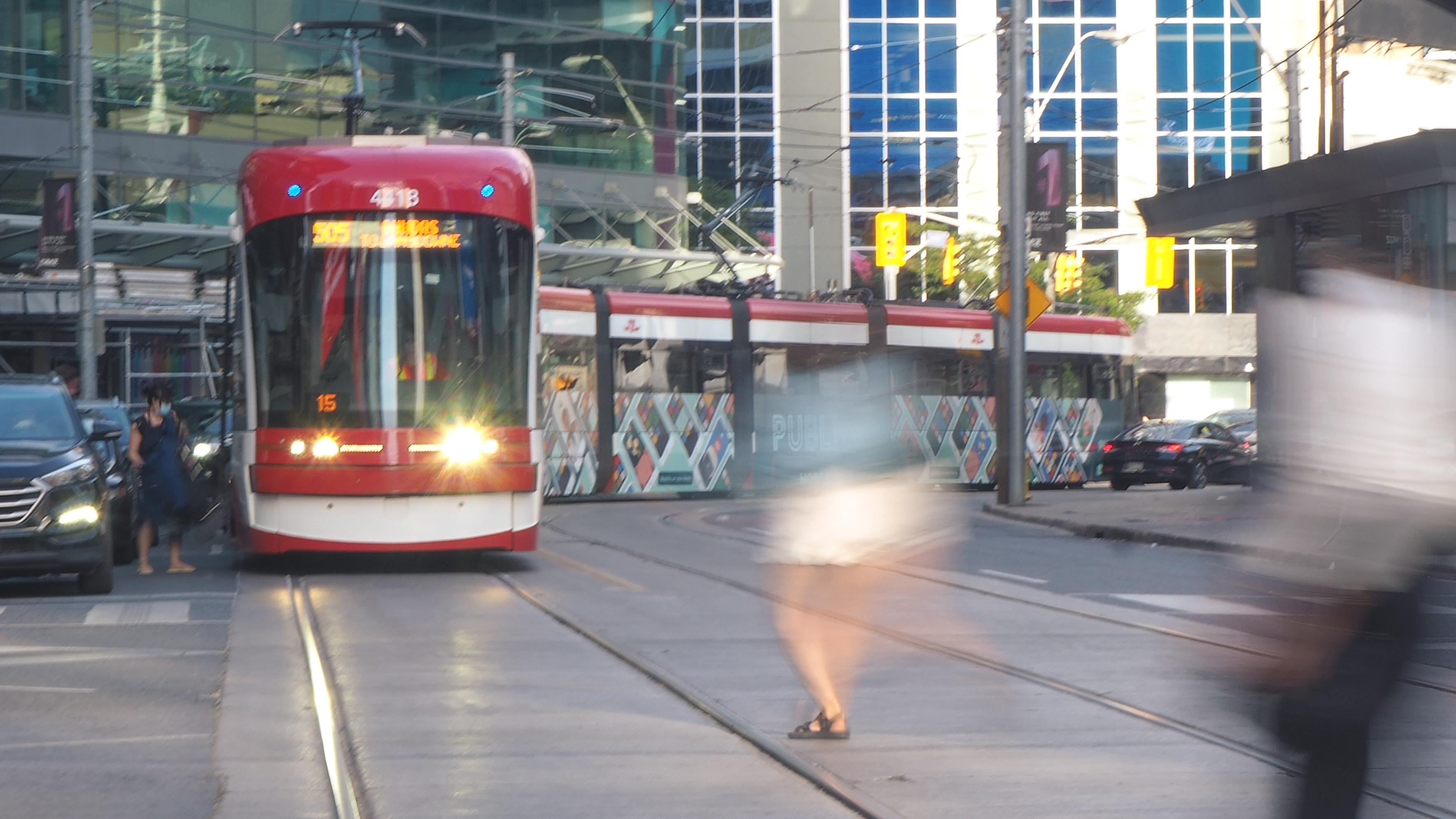 People running to catch a TTC street car