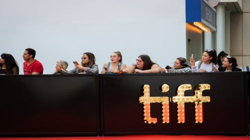 Fans wait at the barricade of the red carpet of Dalíland.