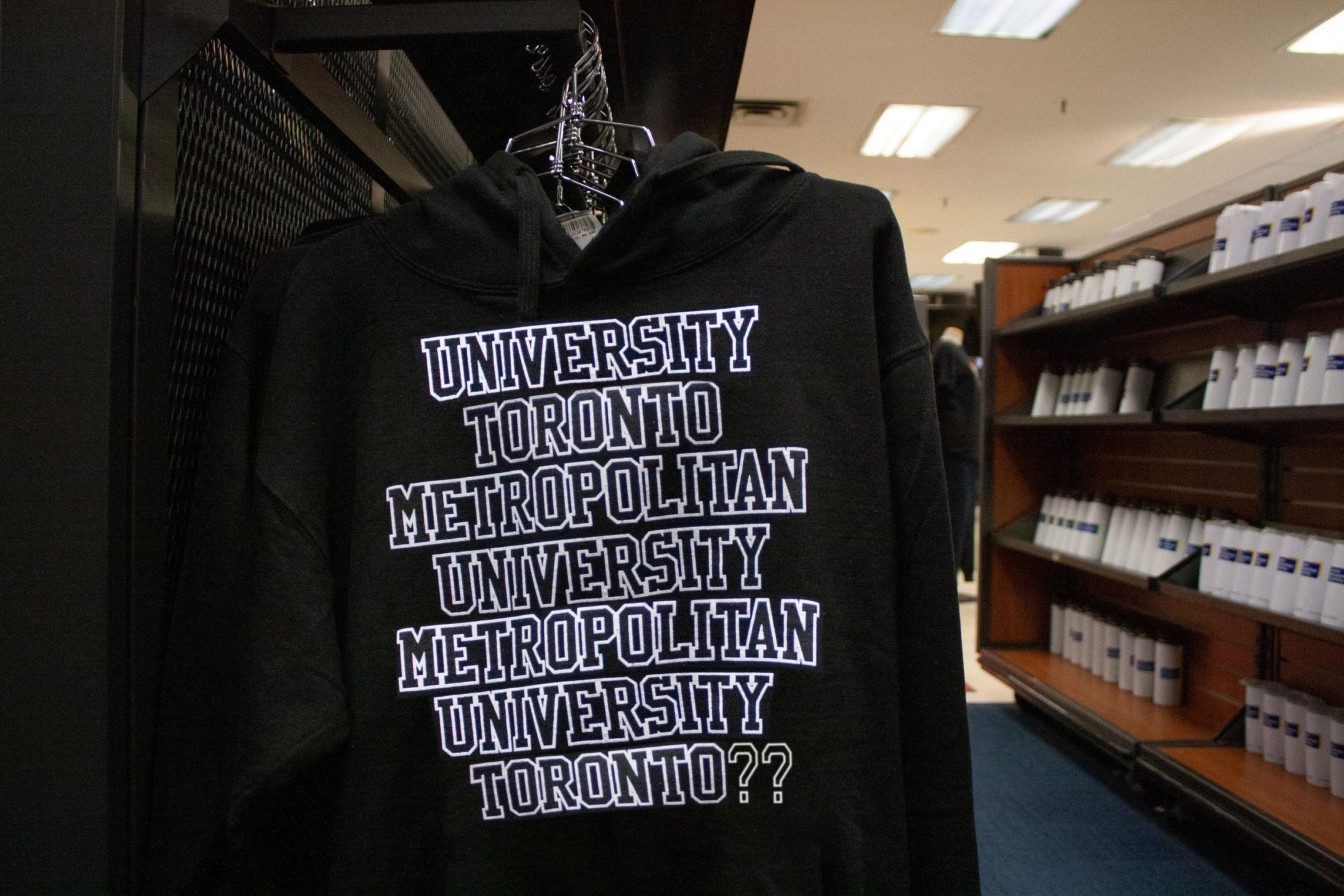 Sweater at the campus store that reads University Toronto Metropolitan University Metropolitan University Toronto question mark question mark