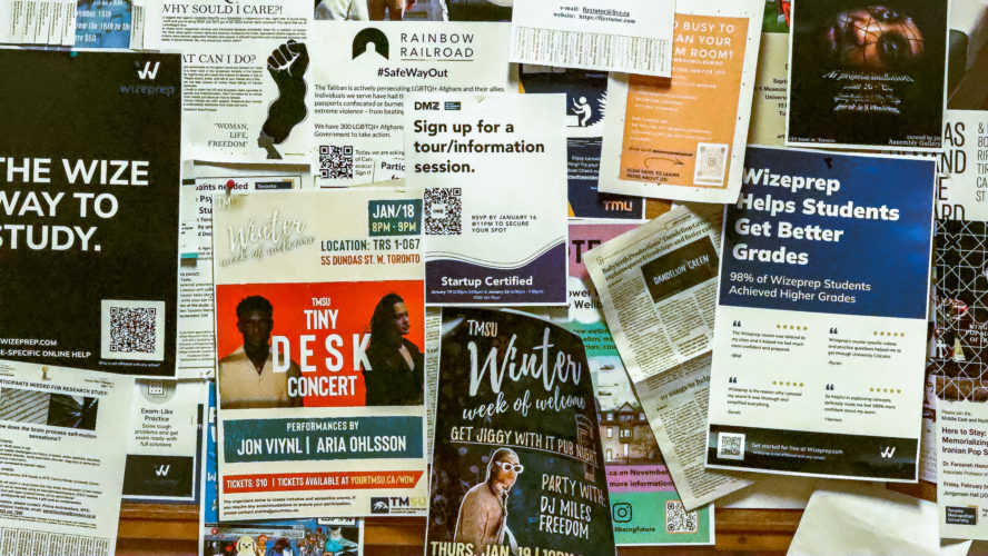 A collection of posters hung up on a bulletin board informing students of campus events