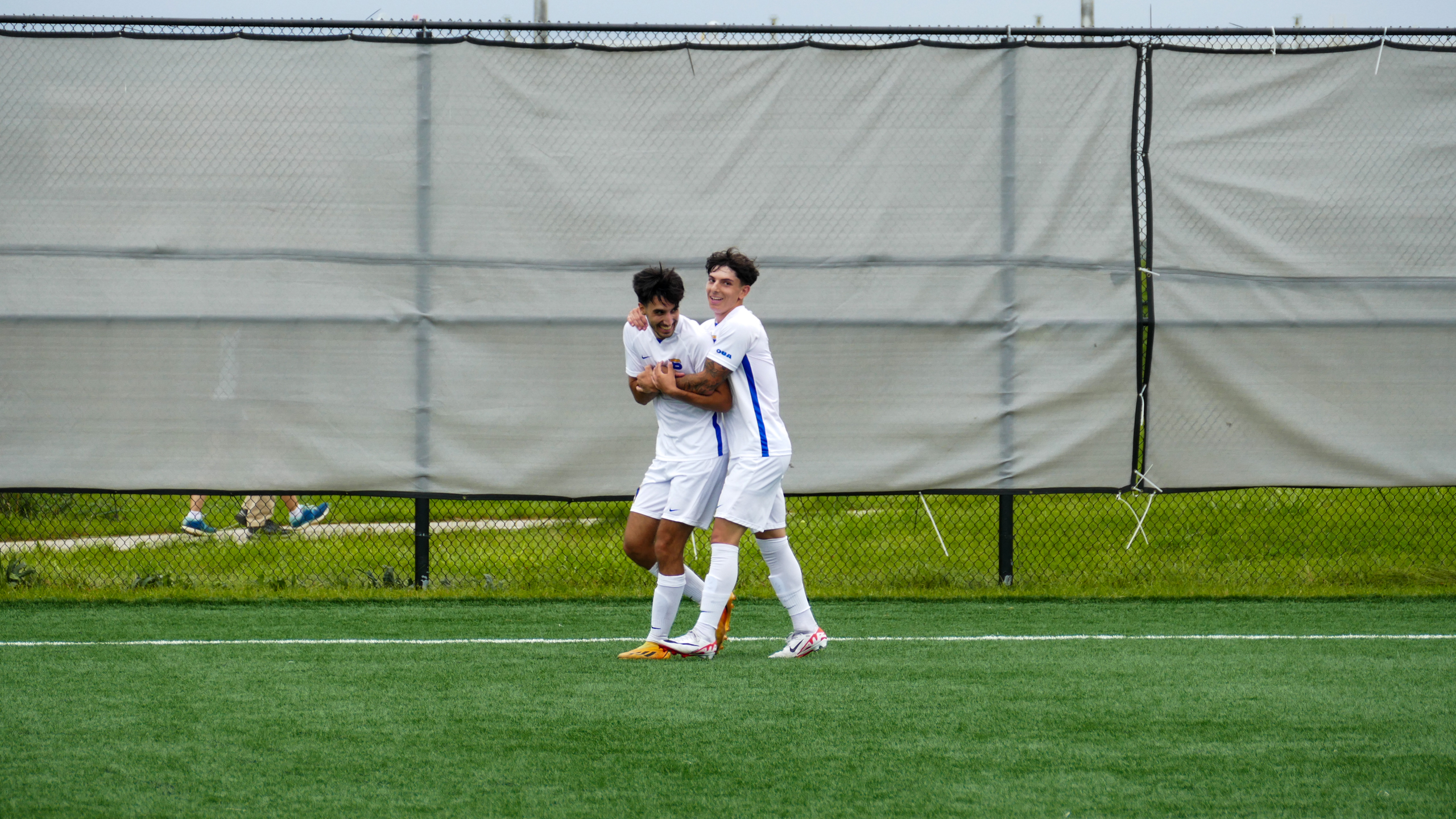 TMU Bold men's soccer players Luca Di Marco and Justin Santos celebrate after Santos scored a goal