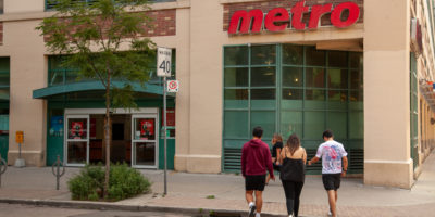 A group of three students walking into the 89 Gould Street Metro location