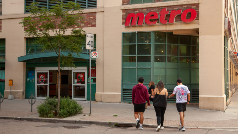 A group of three students walking into the 89 Gould Street Metro location