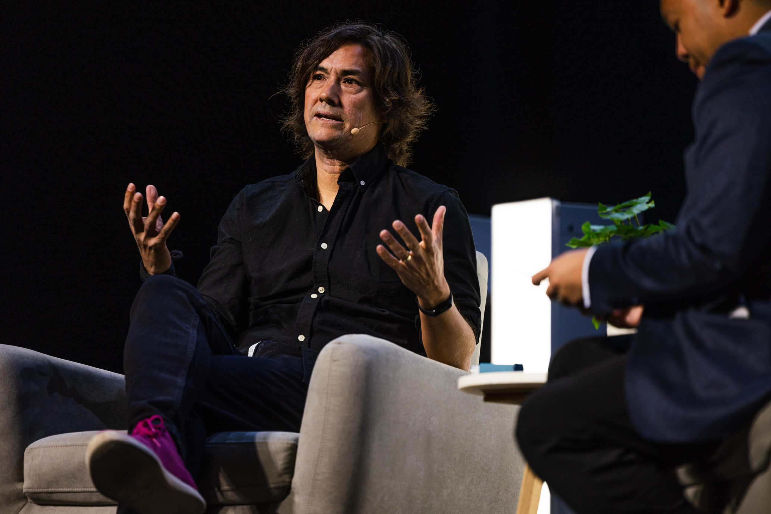 Person in black button down sitting on a chair