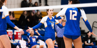 TMU Bold women's volleyball player Mikayla Sheriffs reaches out to high-five her teammates
