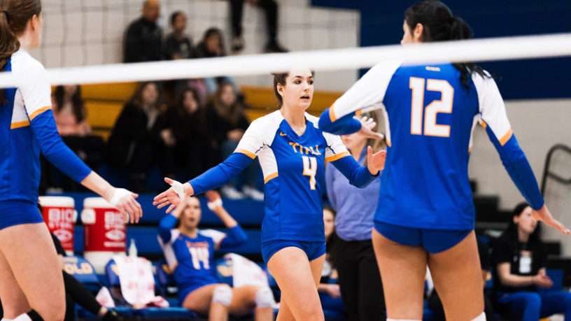 TMU Bold women's volleyball player Mikayla Sheriffs reaches out to high-five her teammates