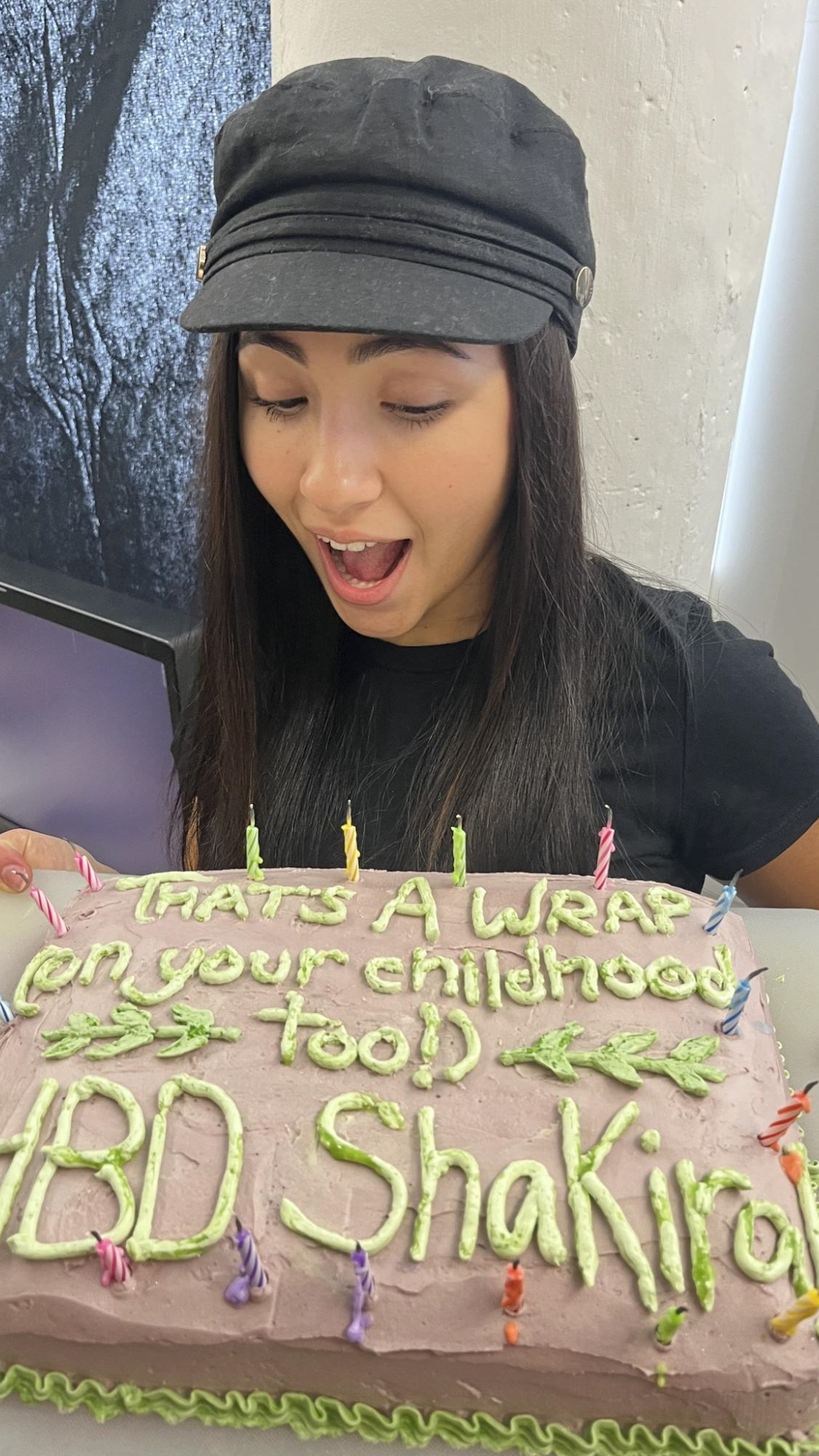 Person looking shocked and happy about a birthday cake
