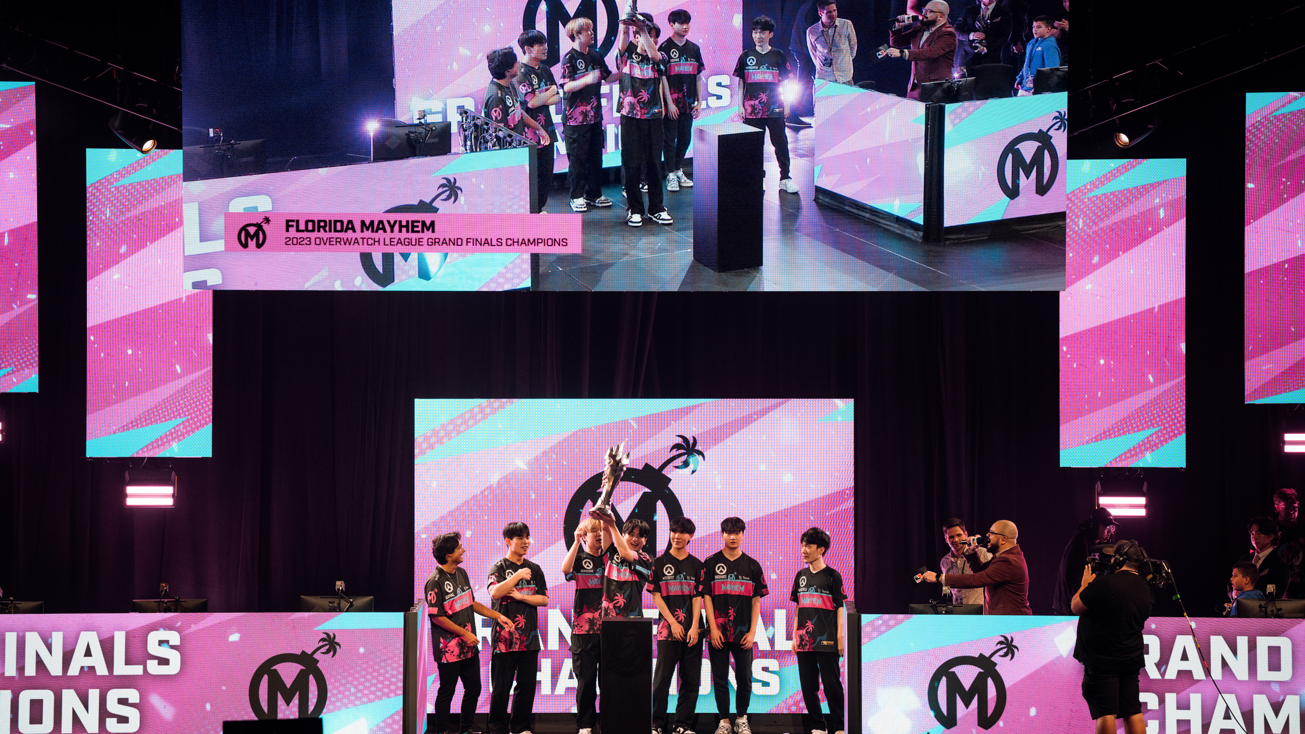 The Florida Mayhem hold the Overwatch League Grand Finals trophy on stage