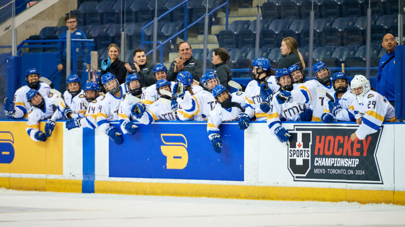 The TMU women's hockey team on the bench at the Mattamy Athletic Centre