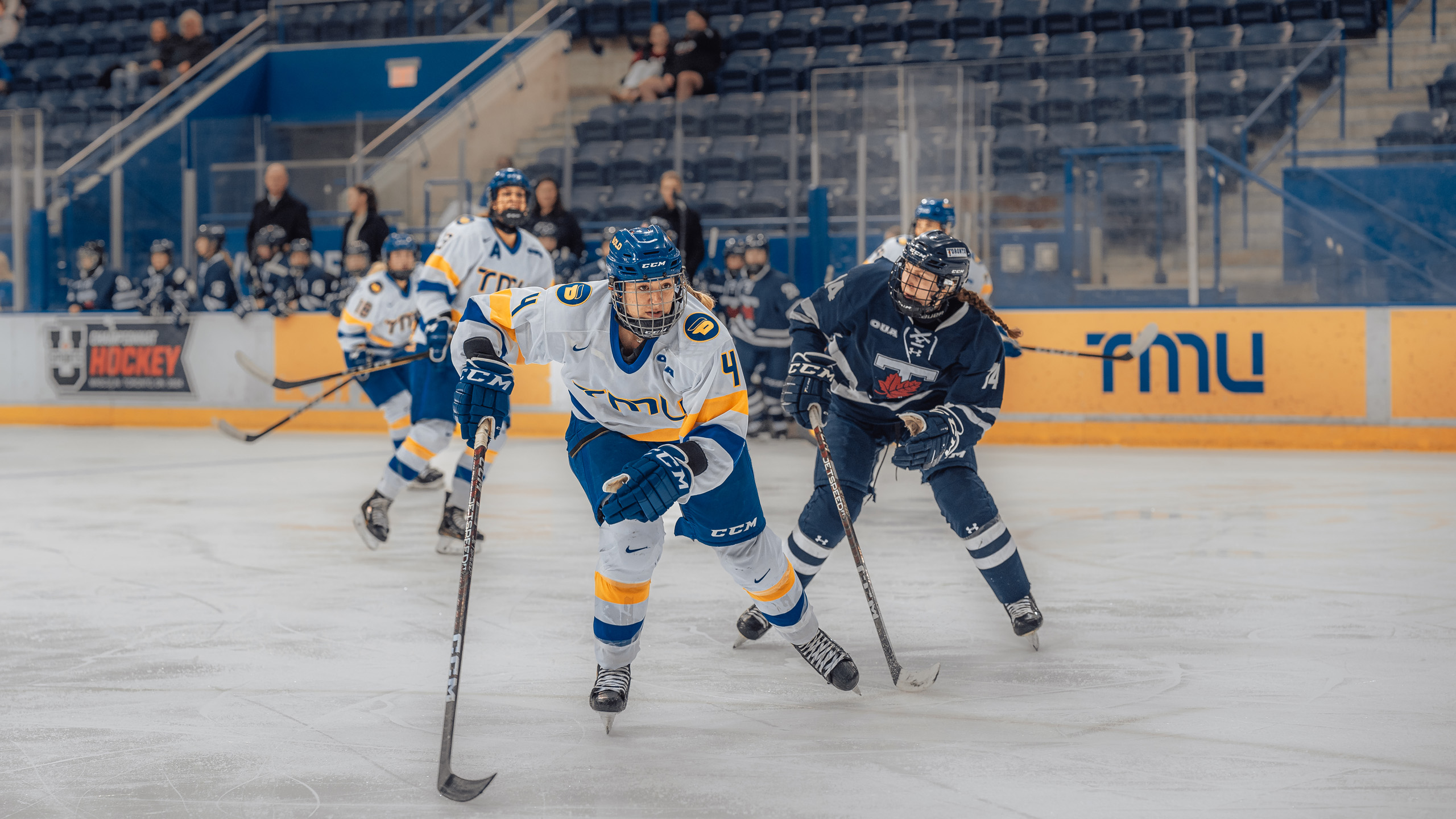 TMU women's hockey defender Lauren McEachen skates into the corner