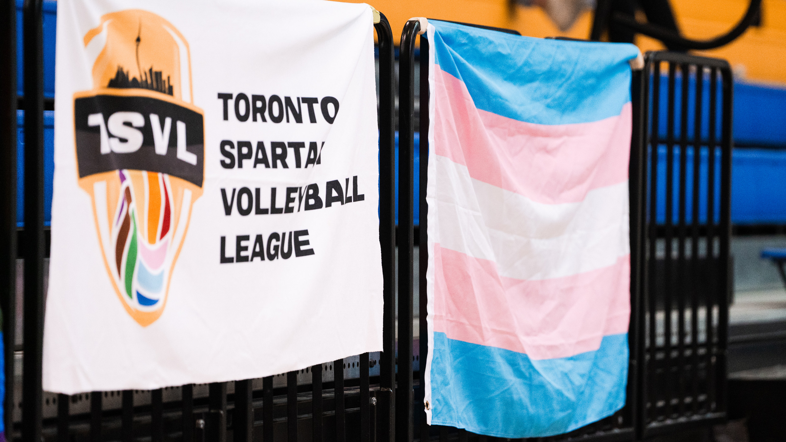 The Transgender flag hung up on the bleachers next to a flag from the Toronto Spartan Volleyball League