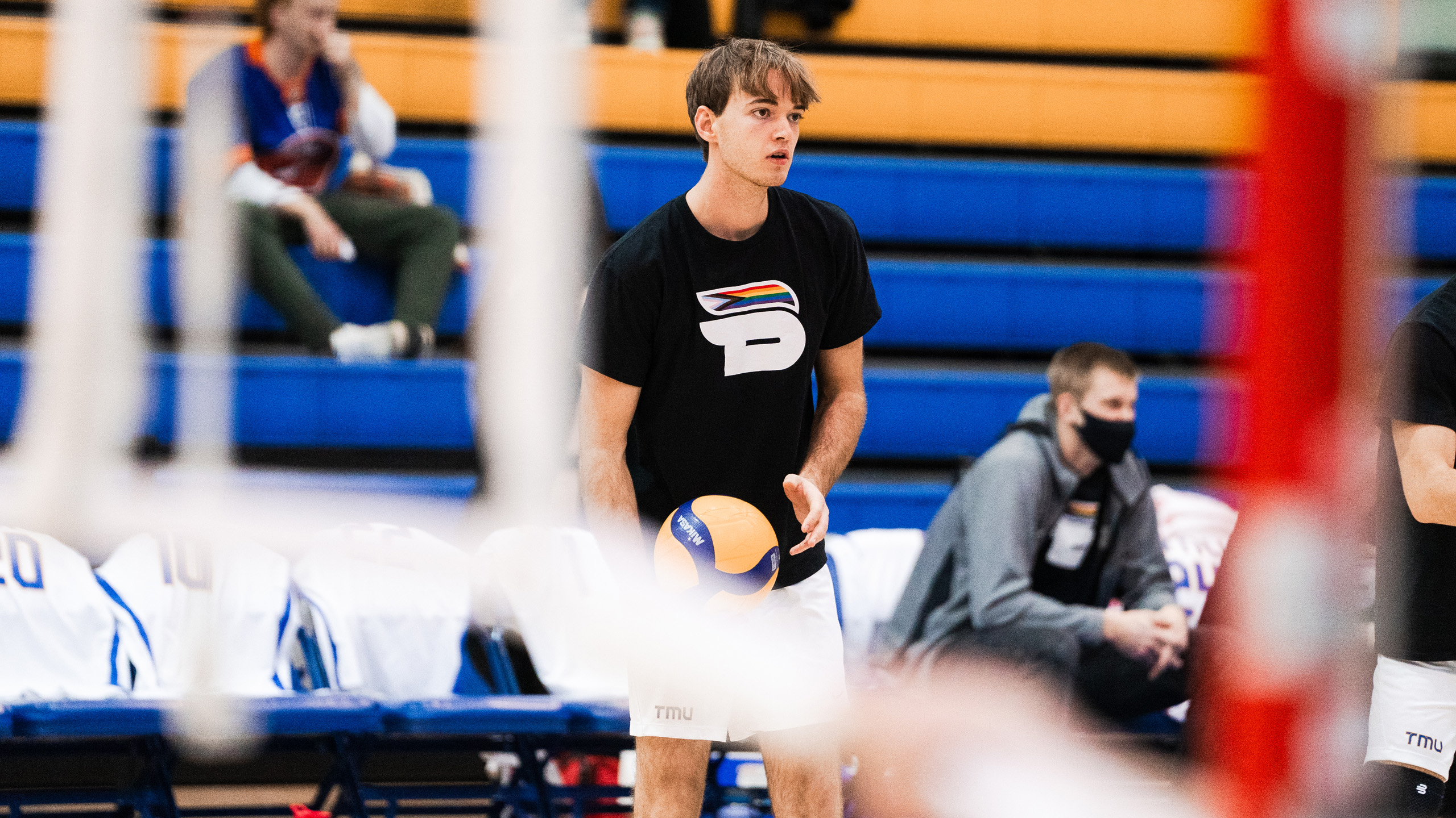 TMU men's volleyball player Lyam Krapp warms up while wearing the Bold Pride shirt