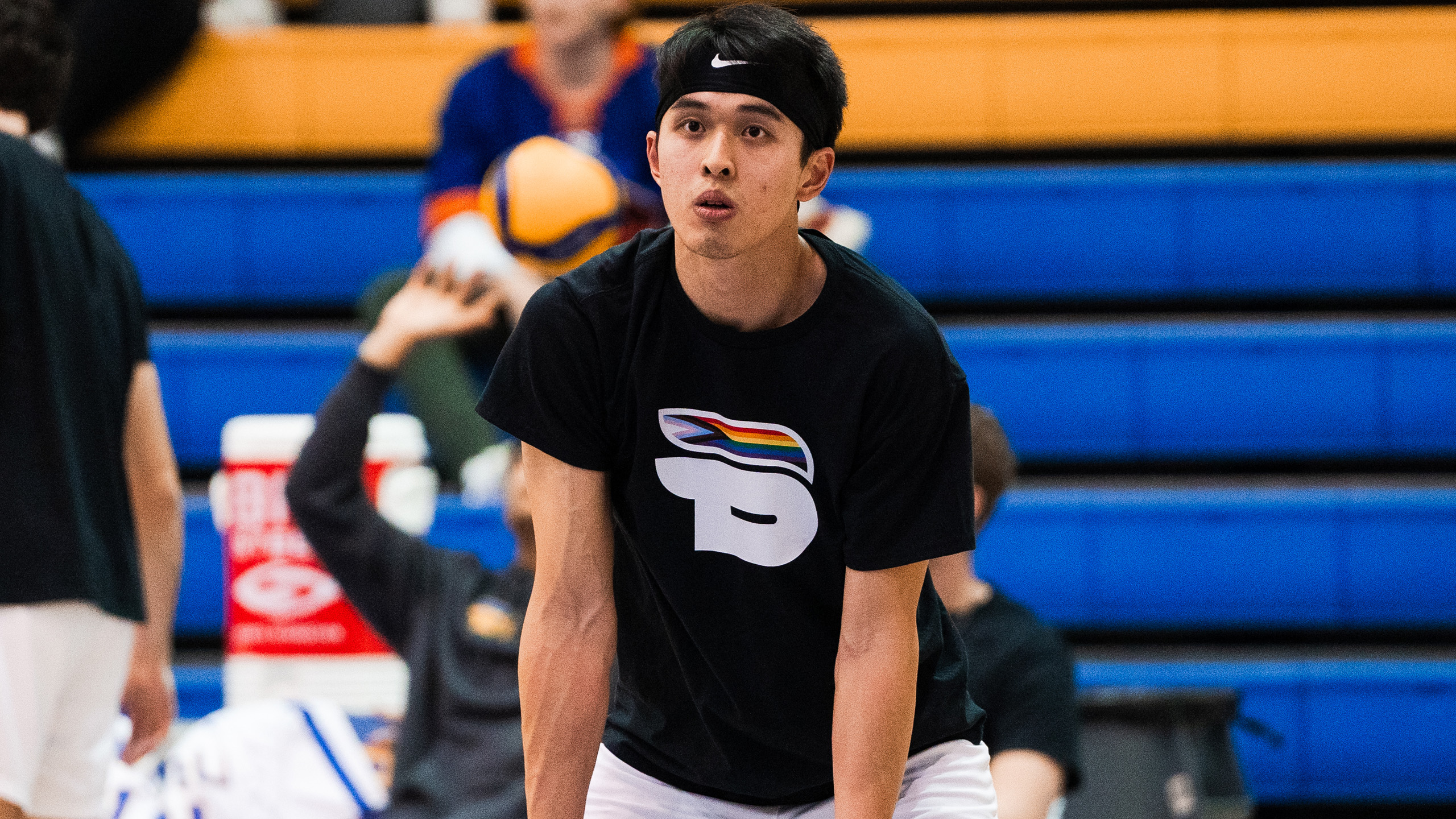 TMU men's volleyball player Bobby Tang wears the Bold Pride shirt in warmups