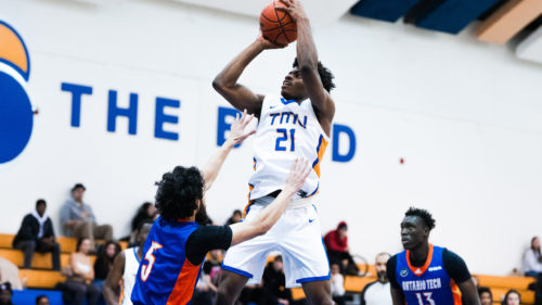 TMU men's basketball player Gabe Gutsmore goes for a jumpshot against a Ridgebacks defender