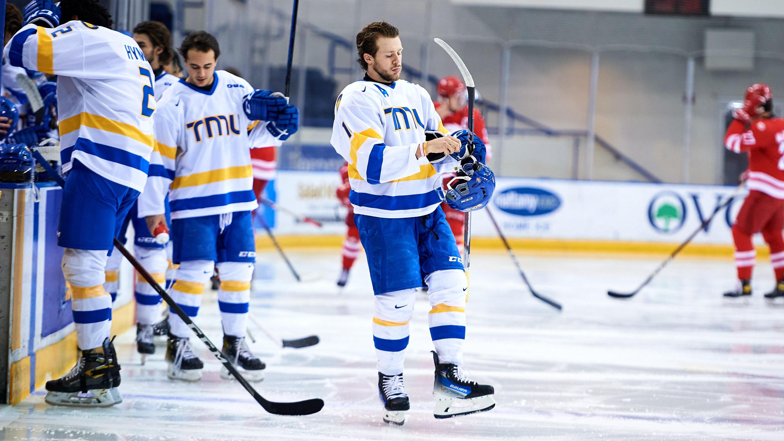 Members of the TMU Bold men's hockey team on the ice at the Mattamy Athletic Centre