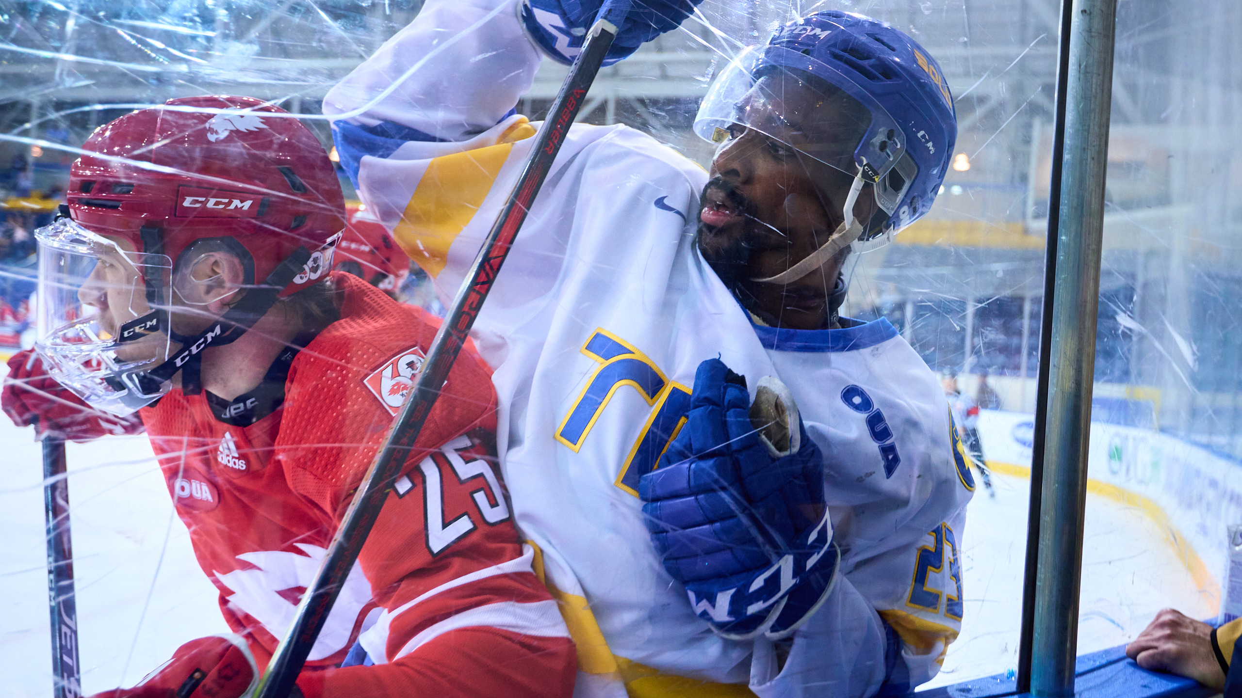 TMU Bold men's hockey player Elijah Roberts is bodied against the boards