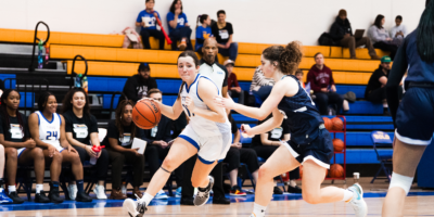 TMU Bold women's basketball player Catrina Garvey drives into the lane with the ball in her hands