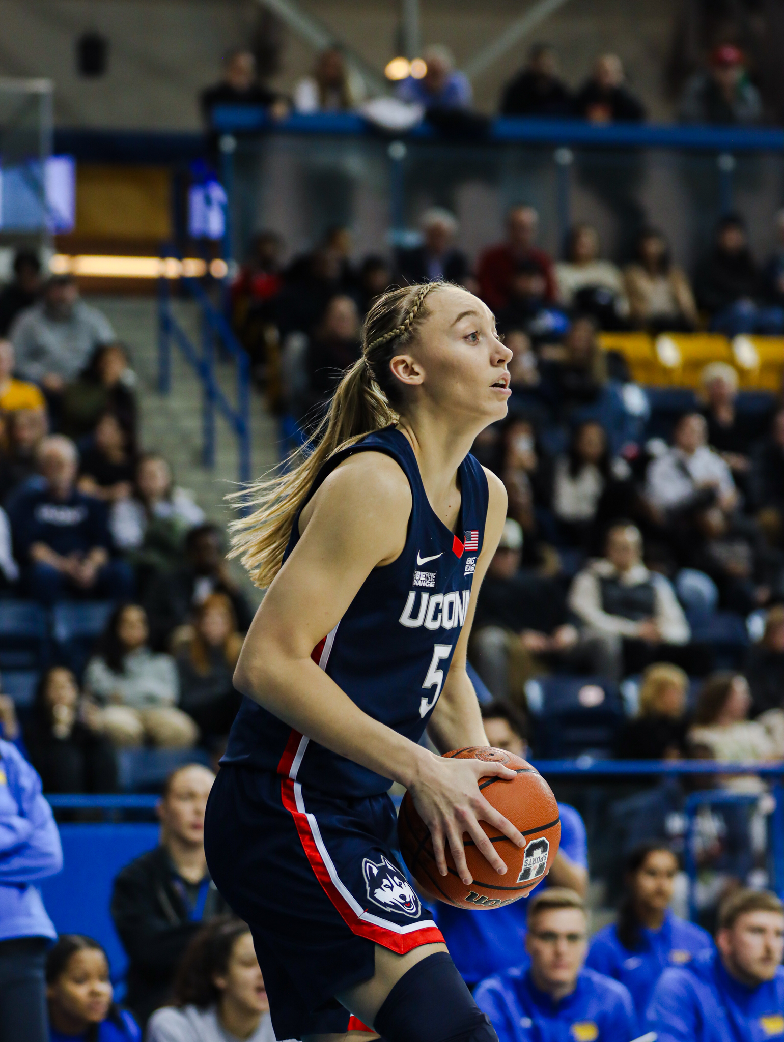 UConn Huskies player Paige Bueckers looks to pass the basketball
