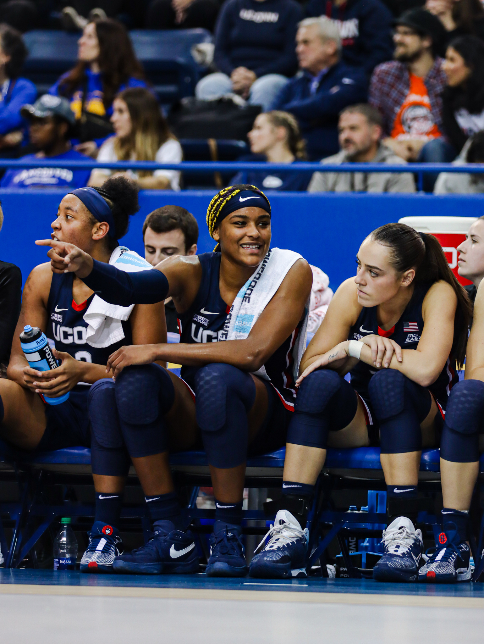 Aaliyah Edwards points as she talks to her teammates while sitting on the bench